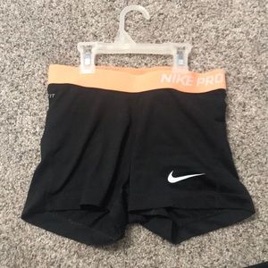 Black Nike Pro 3” spandex w/ bright orange band.